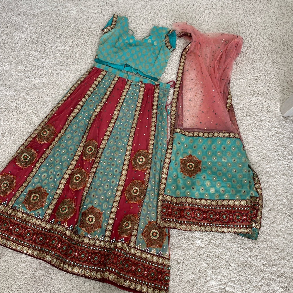 Stunning turquoise, burgundy, gold with a splash of green embroidered Lehenga.